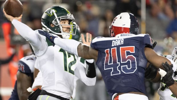 Feb 18, 2023; Houston, TX, USA; Orlando Guardian quarterback Quinten Dormady (12) throws a pass against Houston Roughnecks linebacker John Dana (45) in the fourth quarter at TDECU Stadium. Mandatory Credit: Thomas Shea-USA TODAY Sports  